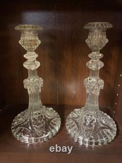 Pair of cut glass candlesticks decorated with lions' and rams' heads, late