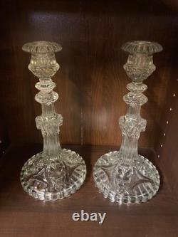 Pair of cut glass candlesticks decorated with lions' and rams' heads, late
