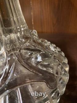 Pair of cut glass candlesticks decorated with lions' and rams' heads, late
