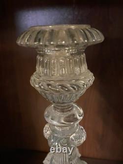 Pair of cut glass candlesticks decorated with lions' and rams' heads, late